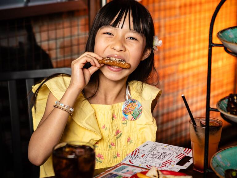 kid at table enjoying meal