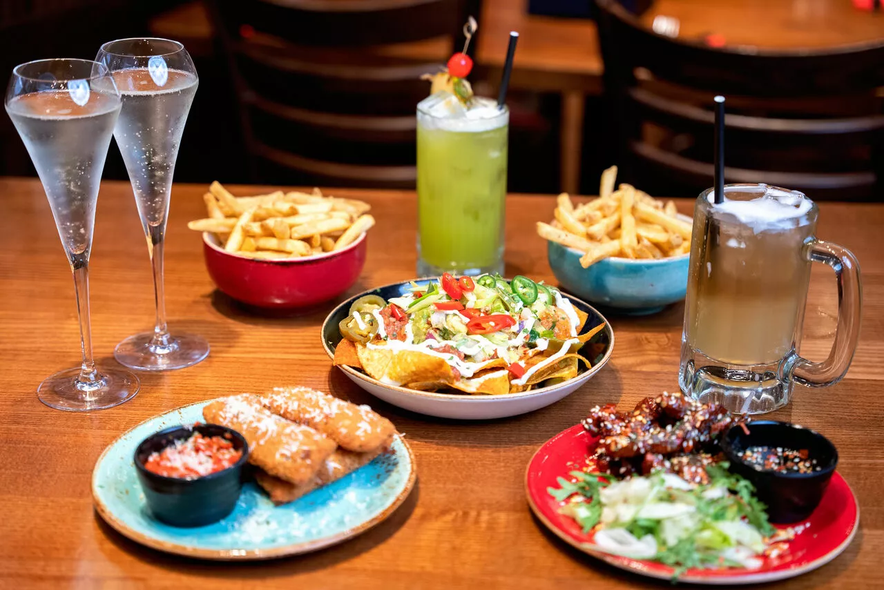Table with plates of food and drink on