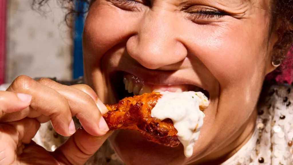 woman biting into food