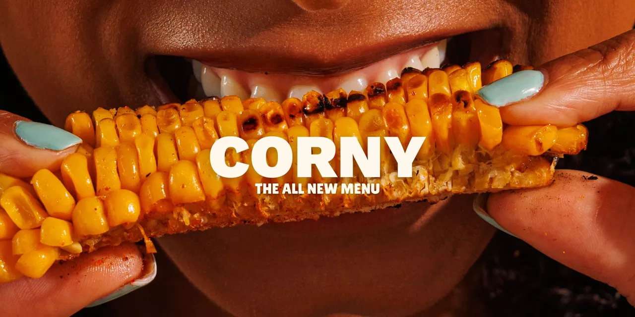 Woman biting into corn