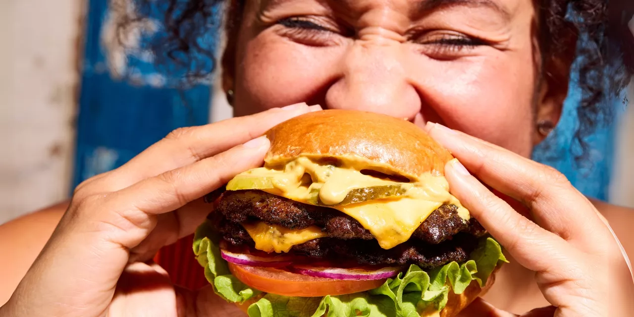 Woman biting burger