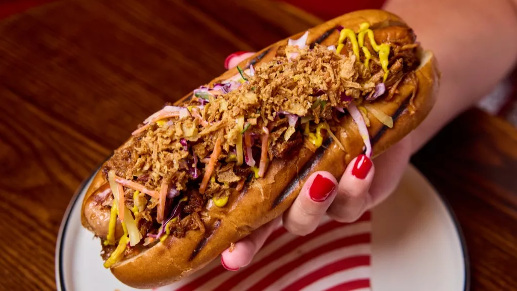 woman holding Chicago-Style Pork Hotdog