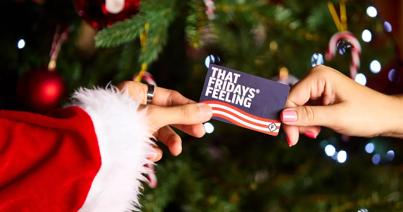 Christmas gift card being handed over