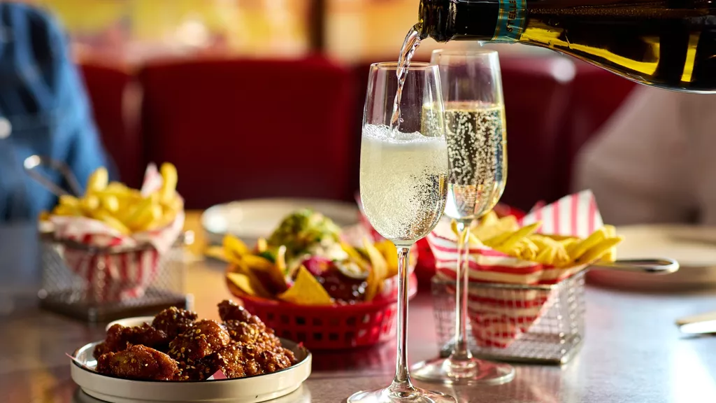 Champaign being poured next to brunch plates