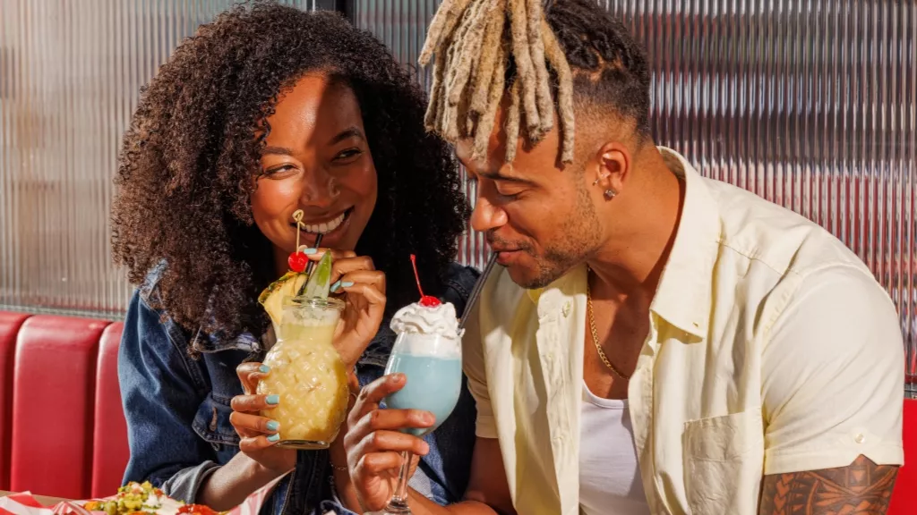 couple sharing cocktails