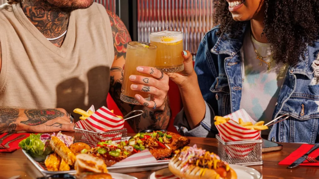 couple enjoying a meal with cocktails
